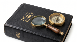 A picture of a Bible with a magnifying glass and a compass